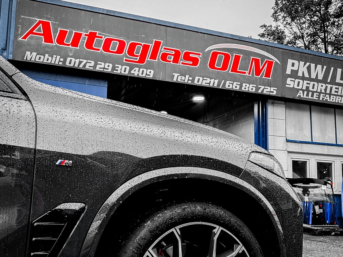 Autoglas OLM premises with company sign and vehicle